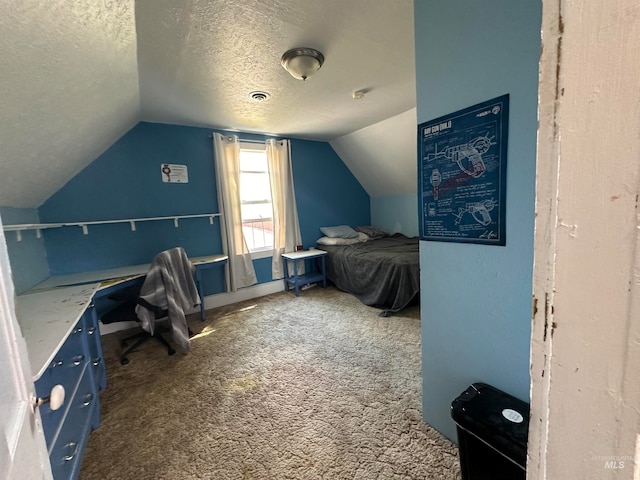 carpeted bedroom featuring a textured ceiling and lofted ceiling