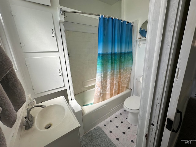 full bathroom with shower / bath combo with shower curtain, tile flooring, vanity, and toilet