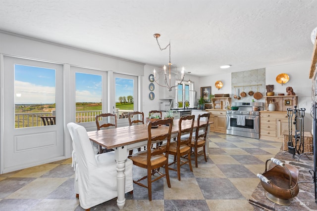 dining space featuring a textured ceiling and a notable chandelier