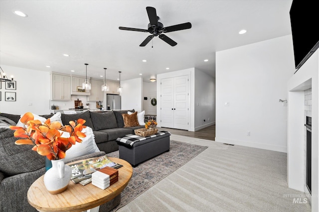 living area with recessed lighting, baseboards, ceiling fan, and a fireplace