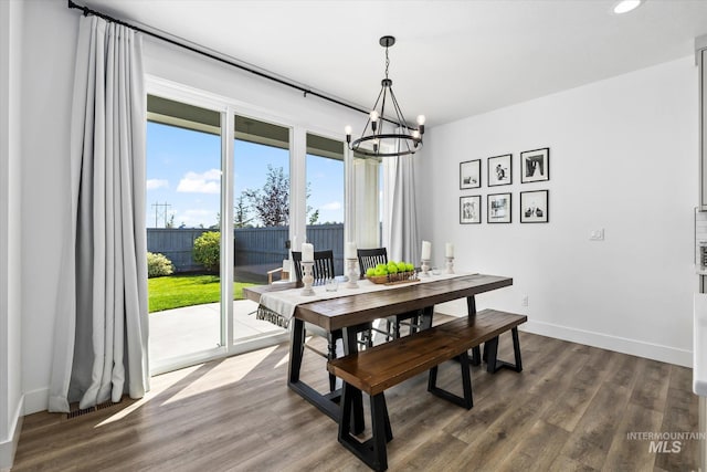 dining room featuring recessed lighting, baseboards, dark wood-style flooring, and a chandelier