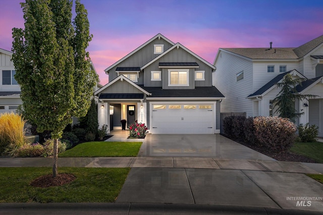 view of front of property featuring board and batten siding, an attached garage, driveway, and a front yard