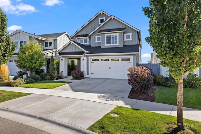 view of front of property with board and batten siding, concrete driveway, metal roof, a garage, and a standing seam roof