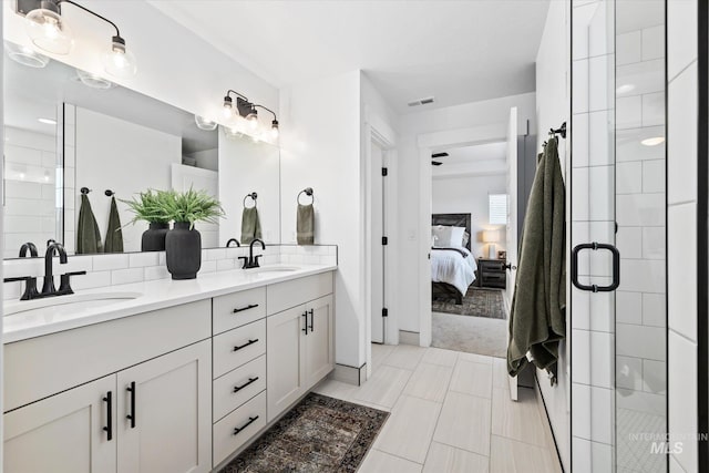 ensuite bathroom with a sink, visible vents, a stall shower, and ensuite bath