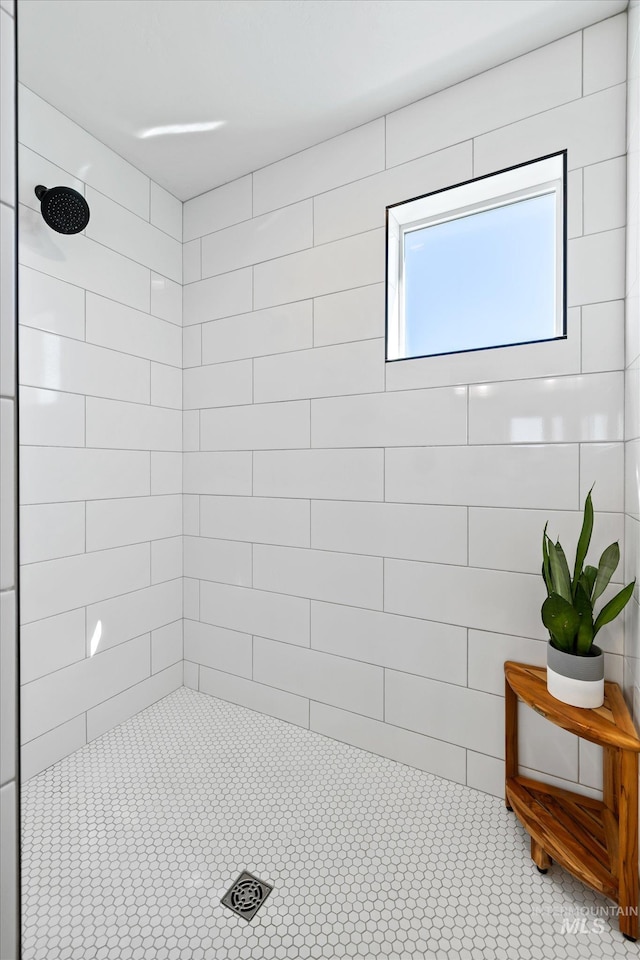 bathroom with tiled shower