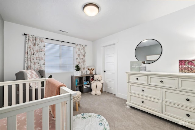 bedroom with light carpet, visible vents, and a nursery area