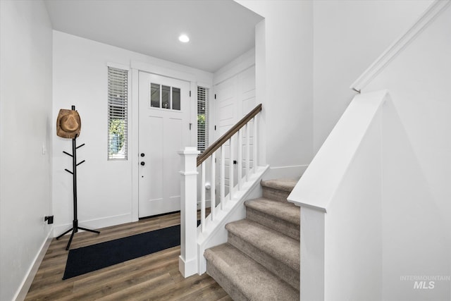 entrance foyer with recessed lighting, stairs, baseboards, and wood finished floors