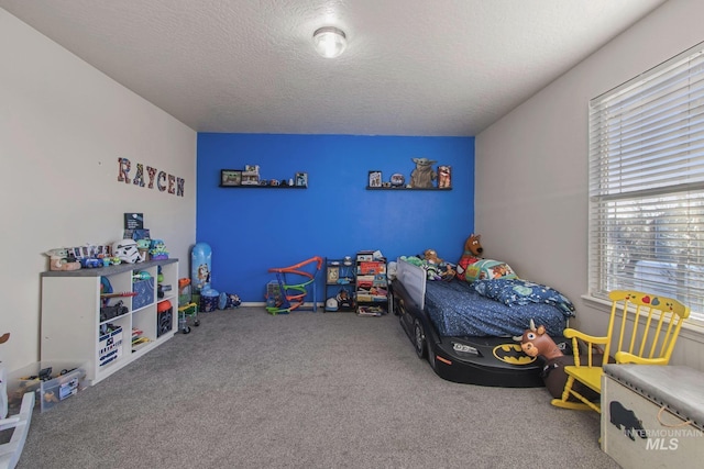 carpeted bedroom with a textured ceiling