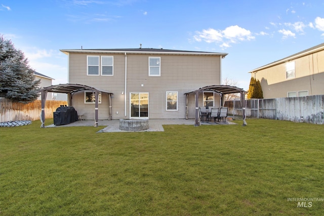 rear view of property featuring a pergola, a gazebo, a yard, and a patio