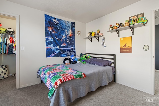 carpeted bedroom with a spacious closet