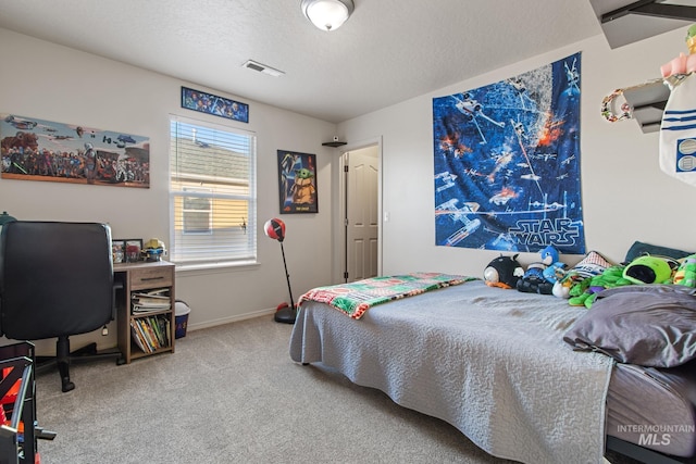 carpeted bedroom with a textured ceiling