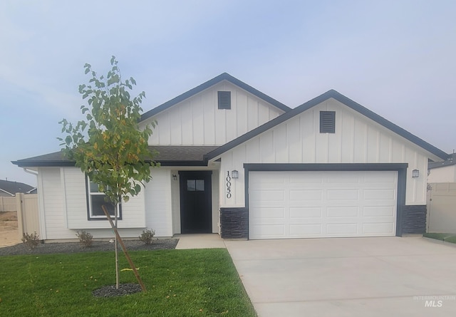 single story home featuring concrete driveway, stone siding, a front lawn, an attached garage, and fence