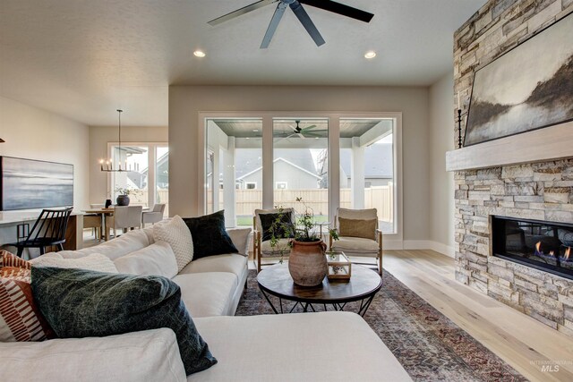 living room featuring light hardwood / wood-style flooring and ceiling fan