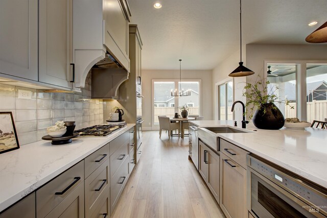 dining space with light hardwood / wood-style flooring, an inviting chandelier, and a healthy amount of sunlight