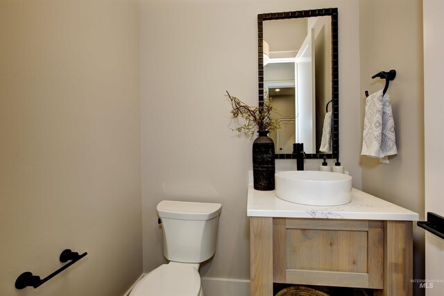 bathroom featuring toilet and vanity