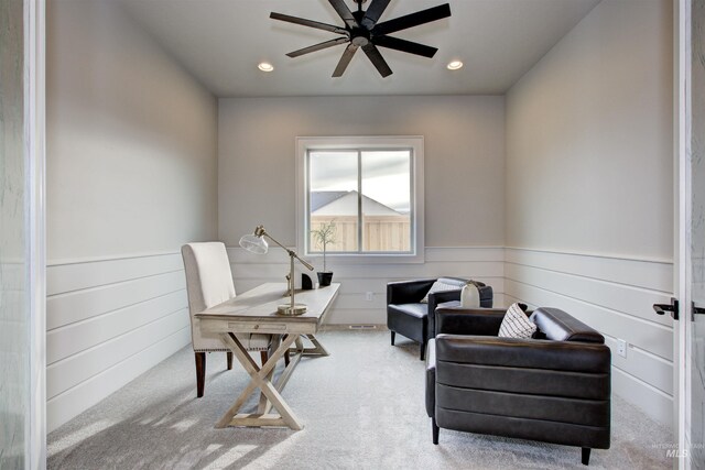 sitting room featuring light colored carpet and ceiling fan