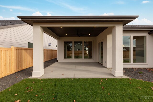 exterior space featuring a lawn, a patio, and ceiling fan