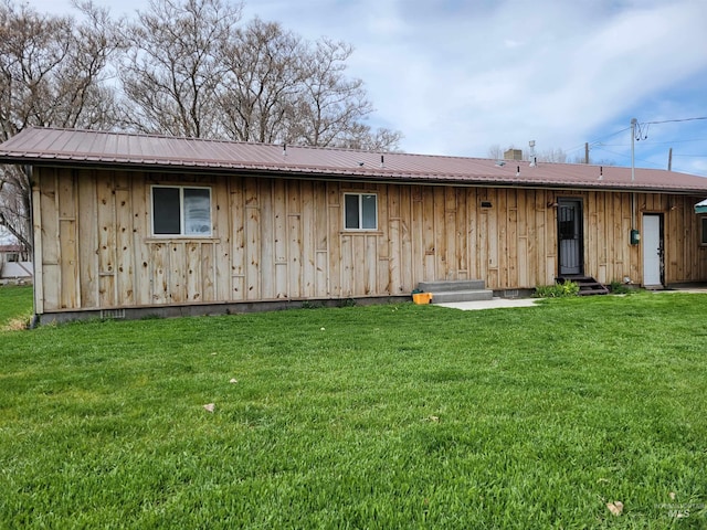 rear view of house featuring a yard