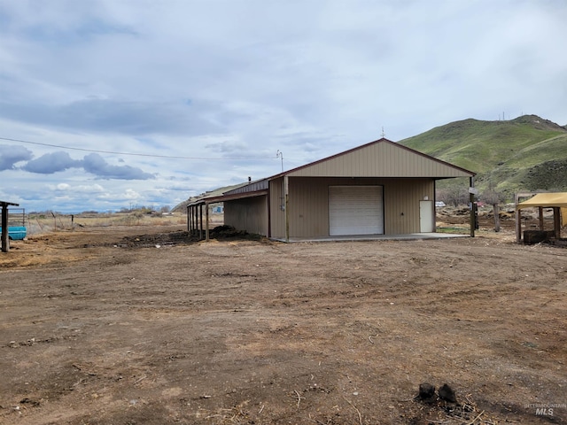 view of outbuilding featuring a mountain view and a garage