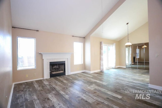 1120 SW 14th Ave, Ontario, OR 97914 - unfurnished living room with wood finished floors, a fireplace, and high vaulted ceiling