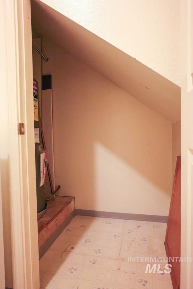 1120 SW 14th Ave, Ontario, OR 97914 - corridor featuring vaulted ceiling, water heater, and light flooring