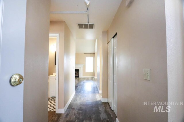 1120 SW 14th Ave, Ontario, OR 97914 - corridor featuring dark wood-style floors and baseboards