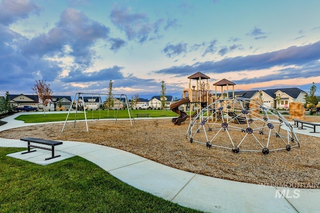 community playground with a lawn and a residential view