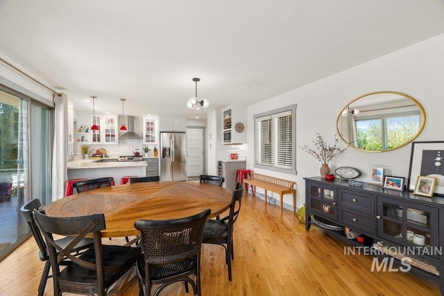 606 S Ridge Rd, Moscow, ID 83843 - dining room featuring light wood-style flooring, healthy amount of natural light, and a chandelier