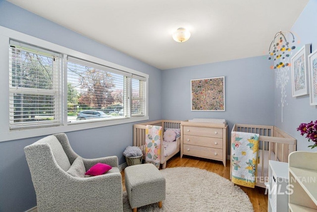 606 S Ridge Rd, Moscow, ID 83843 - bedroom with wood finished floors and a nursery area