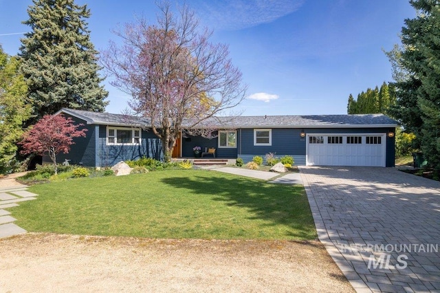 606 S Ridge Rd, Moscow, ID 83843 - single story home featuring a garage, decorative driveway, a front yard, and covered porch