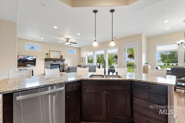 14942 Midway Rd, Nampa, ID 83651 - kitchen featuring dishwasher, a sink, ceiling fan, open floor plan, and dark brown cabinets