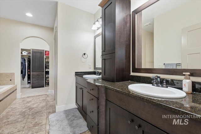 14942 Midway Rd, Nampa, ID 83651 - full bath with double vanity, a spacious closet, tiled tub, and tile patterned floors
