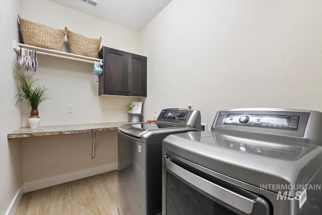14942 Midway Rd, Nampa, ID 83651 - laundry area featuring separate washer and dryer, light wood-style floors, and baseboards
