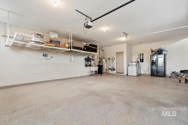 14942 Midway Rd, Nampa, ID 83651 - garage with black refrigerator with ice dispenser, a central vacuum unit, and a garage door opener