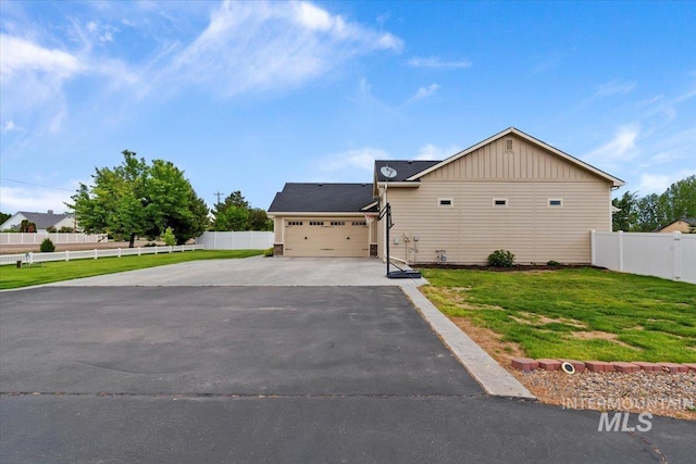 14942 Midway Rd, Nampa, ID 83651 - view of front facade featuring asphalt driveway, board and batten siding, and an attached garage
