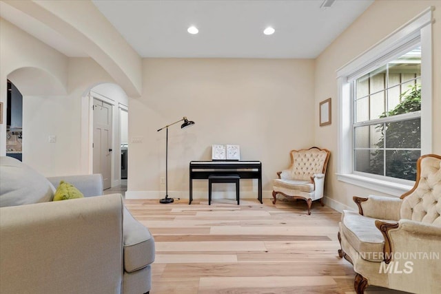14942 Midway Rd, Nampa, ID 83651 - living area with arched walkways, light wood finished floors, recessed lighting, and baseboards