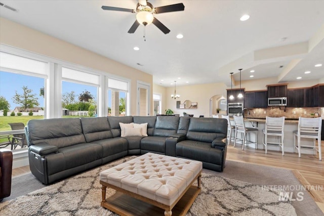 14942 Midway Rd, Nampa, ID 83651 - living room featuring light wood-style flooring, ceiling fan, recessed lighting, and a chandelier