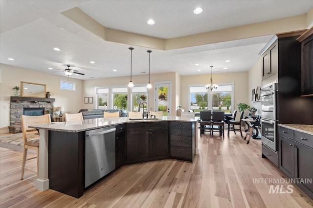 14942 Midway Rd, Nampa, ID 83651 - kitchen featuring stainless steel appliances, a sink, light wood-style floors, light stone countertops, and recessed lighting