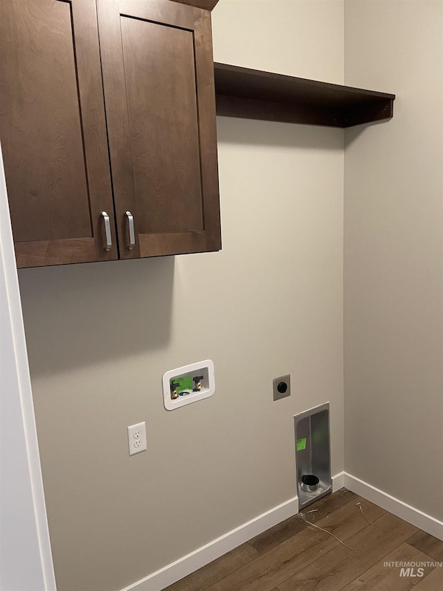 clothes washing area featuring hookup for a washing machine, dark wood-style floors, baseboards, cabinet space, and electric dryer hookup