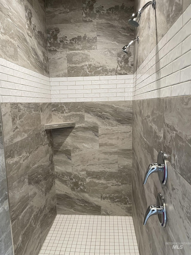 bathroom with a tile shower