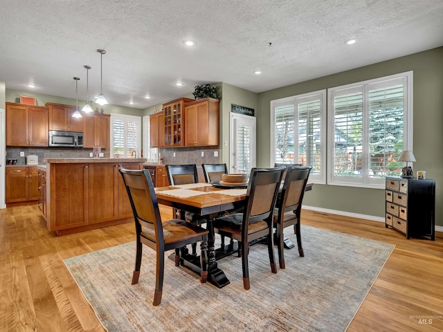 1546 N Dragonfly Ct, Eagle, ID 83616 - dining space featuring baseboards, light wood-type flooring, a textured ceiling, and recessed lighting