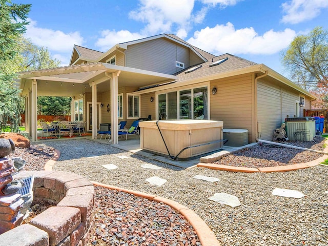 1546 N Dragonfly Ct, Eagle, ID 83616 - rear view of house featuring a patio, roof with shingles, central AC unit, and a hot tub