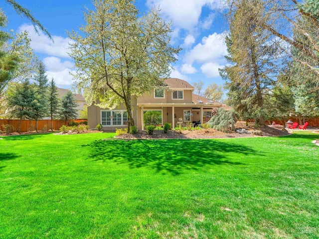 1546 N Dragonfly Ct, Eagle, ID 83616 - rear view of house with fence and a lawn