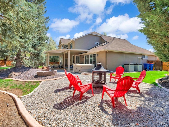 1546 N Dragonfly Ct, Eagle, ID 83616 - back of house featuring a patio area, fence, a fire pit, and a hot tub