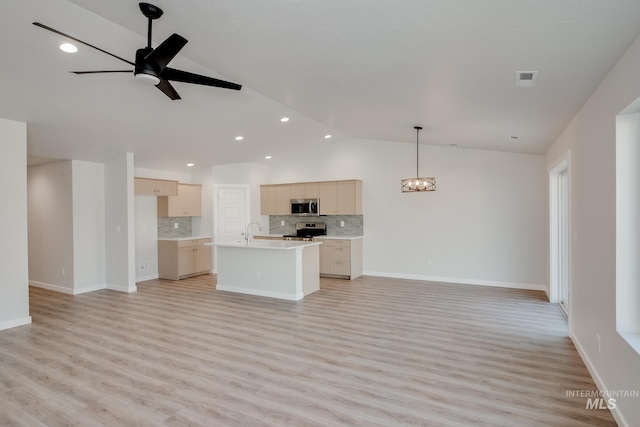 unfurnished living room featuring lofted ceiling, sink, ceiling fan with notable chandelier, and light wood-type flooring