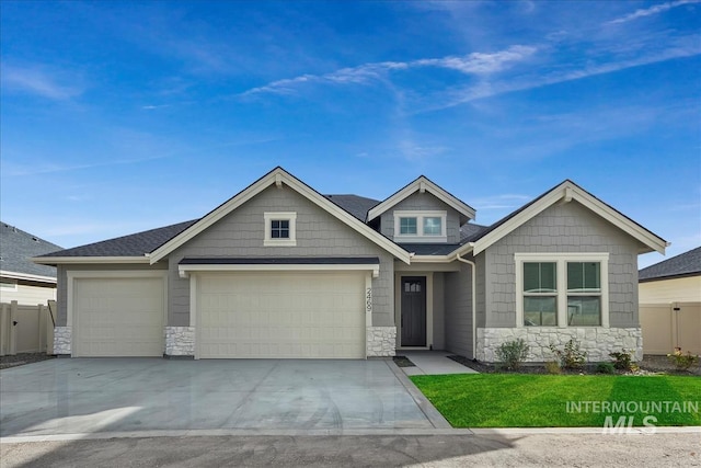 11270 S Saylis Way, Kuna, ID 83634 - view of front of house with stone siding, a garage, and concrete driveway