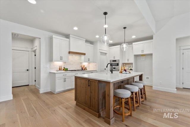 11270 S Saylis Way, Kuna, ID 83634 - kitchen featuring recessed lighting, white cabinetry, tasteful backsplash, light countertops, and light wood-style floors