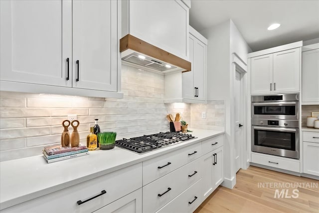 11270 S Saylis Way, Kuna, ID 83634 - kitchen with stainless steel appliances, light wood-type flooring, white cabinets, and light countertops