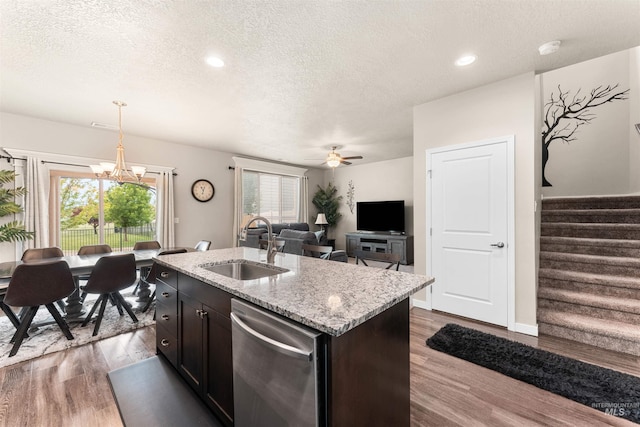 3065 E Ionia Ct, Meridian, ID 83642 - kitchen with dishwasher, a sink, a textured ceiling, dark wood finished floors, and a chandelier