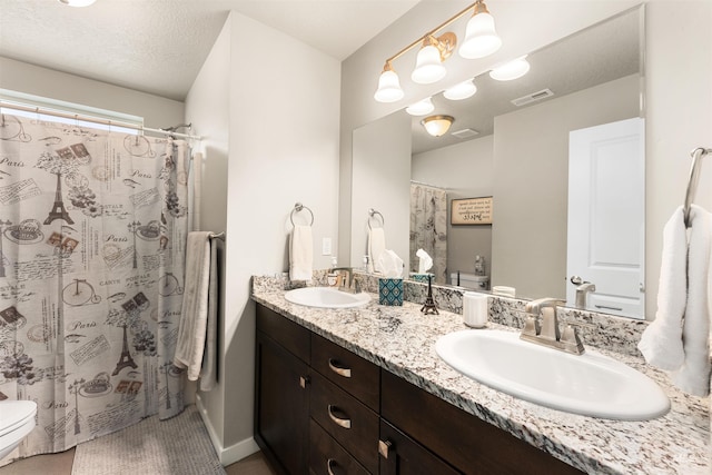 3065 E Ionia Ct, Meridian, ID 83642 - full bathroom with toilet, double vanity, and a shower with shower curtain